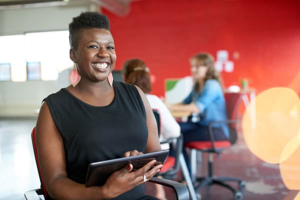 Lady smiling while holding a tablet