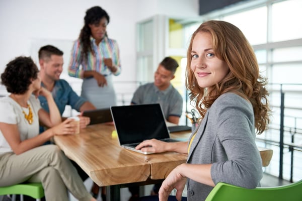 woman wryly looking at the camera during a meeting