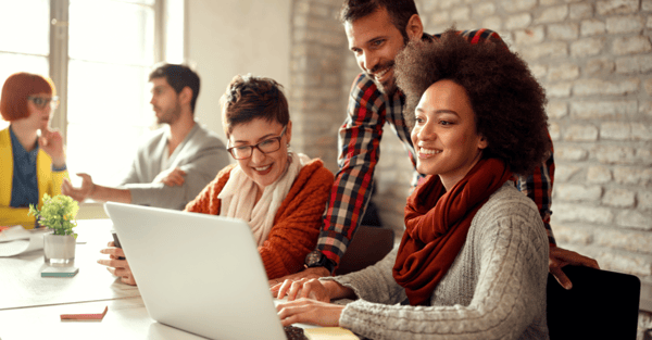 Three creative agency employees reviewing a project charter