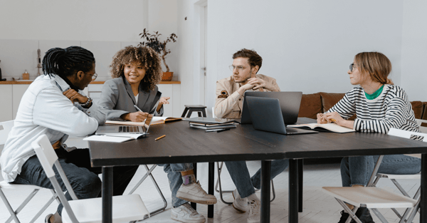 Image of a cross-functional team of four creative professional working together on a project